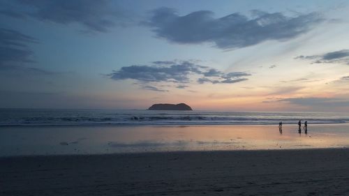 Scenic view of beach against sky during sunset