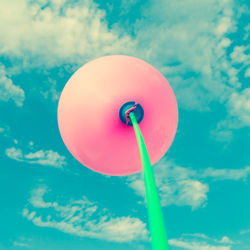 Low angle view of balloons against blue sky