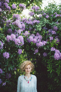 Woman against purple flowering plants