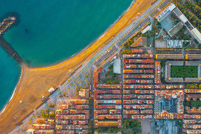 View of residential buildings on the oceanfront in barcelona spain. sea spit in blue water.