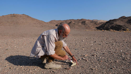 Archaeologist at work in the desert 