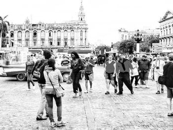 Group of people walking on street in city