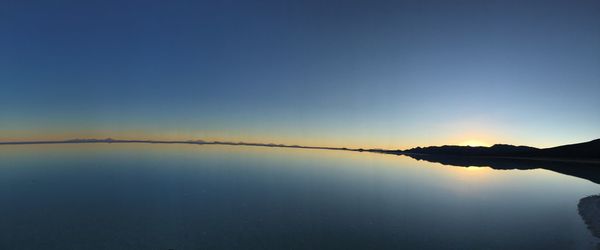 Scenic view of lake against clear blue sky