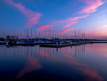 Sailboats in marina at sunset