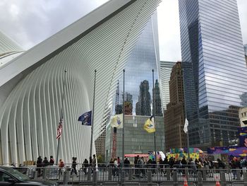 People on street against buildings in city