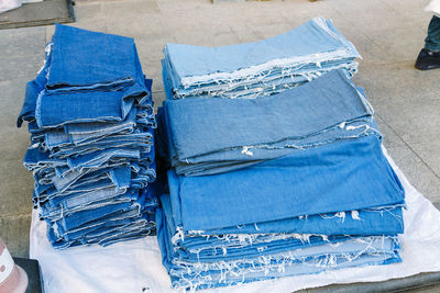 Denims stacked on table for sale at street