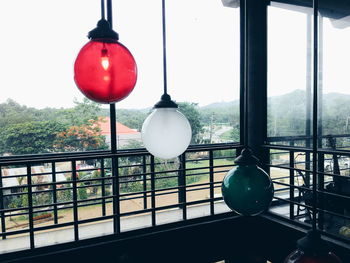 Close-up of lighting equipment hanging by railing against building