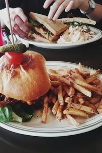 Close-up of hamburger with french fries in plate