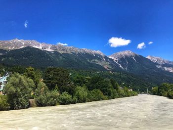 Scenic view of snowcapped mountains against blue sky