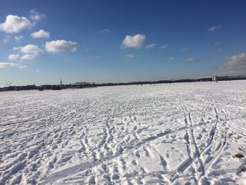 Scenic view of snow covered field against sky