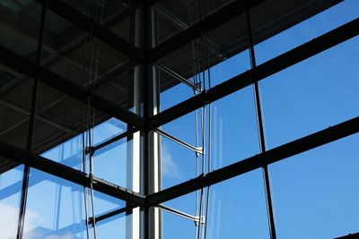 Low angle view of modern building against blue sky