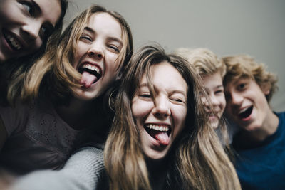 Low angle view of cheerful friends at home