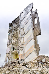 Low angle view of abandoned building against sky