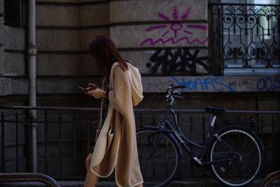 Side view of woman using mobile phone