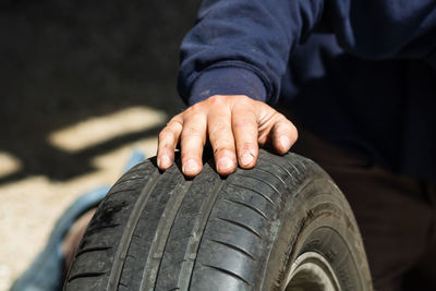 Midsection of man holding car