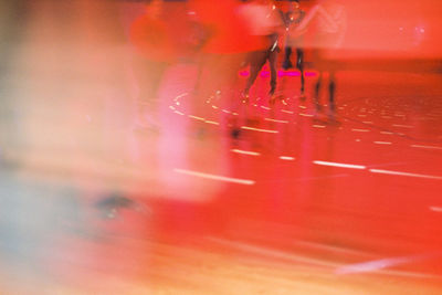 Low section of people on red glass