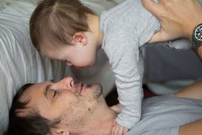 Close-up of baby lying on bed