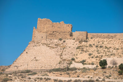 Low angle view of historic building against blue sky