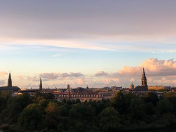 Panoramic view of buildings in city against sky during sunset