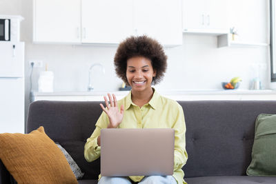 Young woman using laptop at home