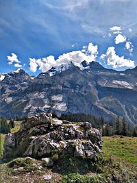 Scenic view of mountains against cloudy sky