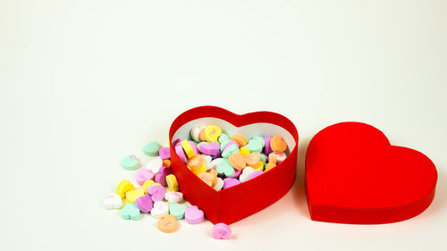 Close-up of multi colored heart shape over white background