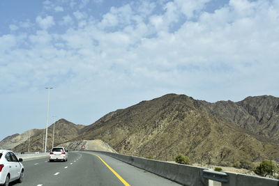 Cars on road against sky