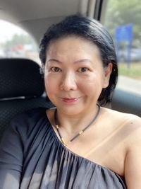 Portrait of smiling woman in car