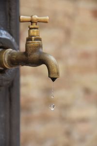 Close-up of water drops dripping from faucet