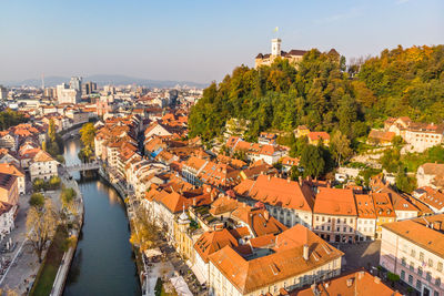 High angle view of townscape by river in city