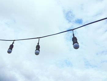 Low angle view of light bulb against sky