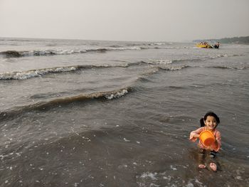 Portrait of boy on beach against sky