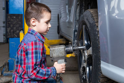 Boy holding a car