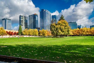 Buildings in park against sky