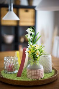 Close-up of flower vase on table at home