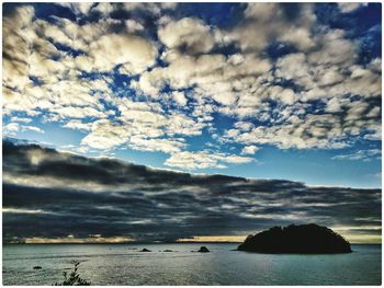 Scenic view of sea against cloudy sky