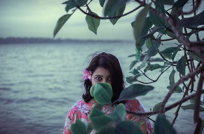 Portrait of woman against plants