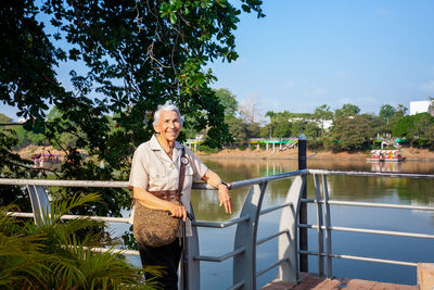 Senior woman at the ronda del sinu walking path along the river bank in montería, colombia.