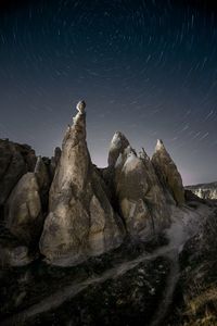 Rock formation against sky at night