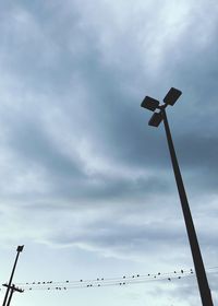 Low angle view of street light against cloudy sky