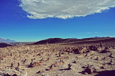 Scenic view of desert against blue sky