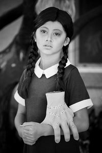 Portrait of teenage girl holding outdoors