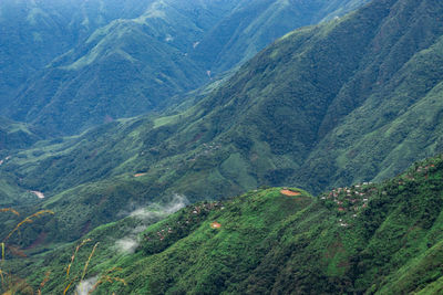 Mountain range downhill peak with light mist at morning from top angle