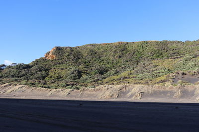 Scenic view of mountains against clear blue sky