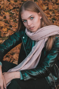 Portrait of a beautiful young woman sitting outdoors