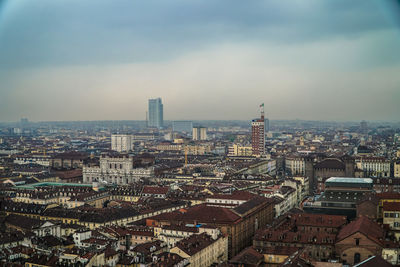 High angle view of illuminated city buildings against sky