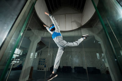 Low section of man jumping in gym