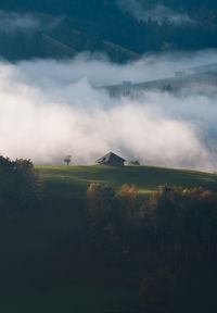 Scenic view of landscape against sky during foggy weather