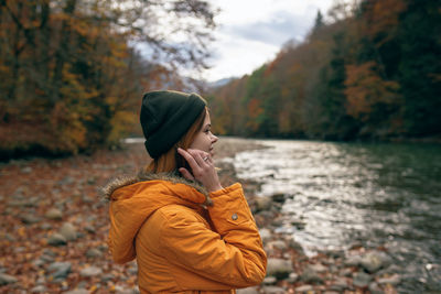 Midsection of man holding umbrella during autumn