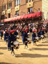 People on street against buildings